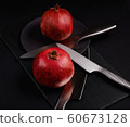 Pomegranate with Christmas decorations on dark 60673128