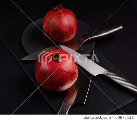 Pomegranate with Christmas decorations on dark 60673128