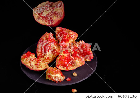 Pomegranate with Christmas decorations on dark 60673130