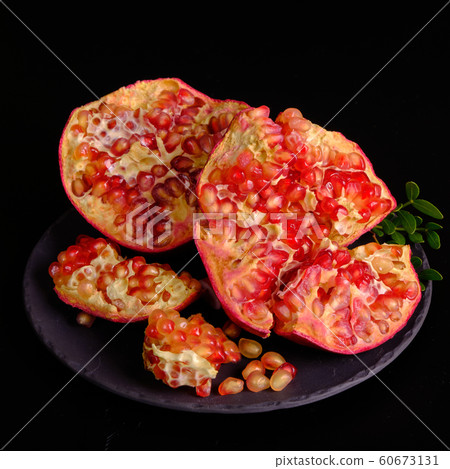 Pomegranate with Christmas decorations on dark 60673131