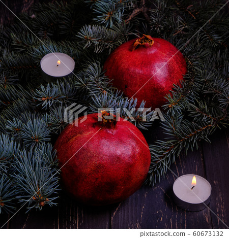 Pomegranate with Christmas decorations on dark 60673132