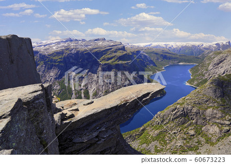 Scenic view of Trolltunga (The famous Troll's tongue Norwegian destination) and Ringedalsvatnet Lake in Odda, Roldal, Norway Scenic view of Trolltunga (The famous Troll's tongue Norwegian destination) and Ringedalsvatnet Lake in Odda, Roldal, Norway 60673223