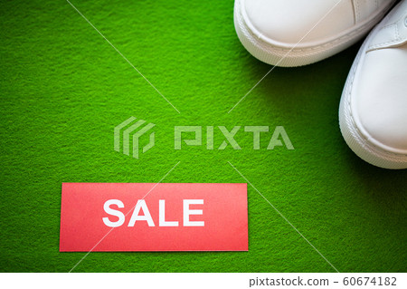 Stylish white fashion sneakers on gren background. Stylish white fashion sneakers on gren background. 60674182