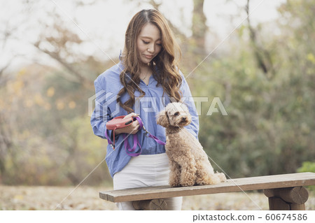 Woman walking park with pet 60674586
