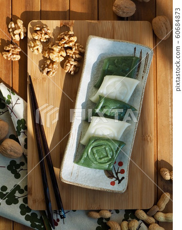 Korean traditional rice cake, slices and walnuts Korean traditional rice cake, slices and walnuts 60684873