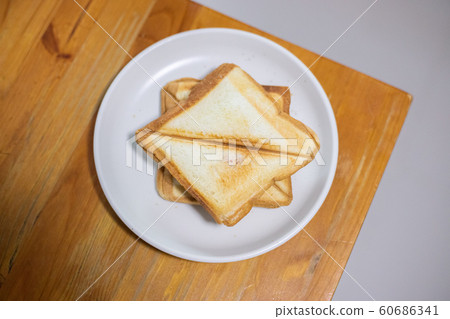 Toasted Bread Photos, On a white plate on a wooden 60686341