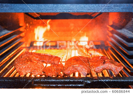 Grilling pork ribs in stove close up 60686844