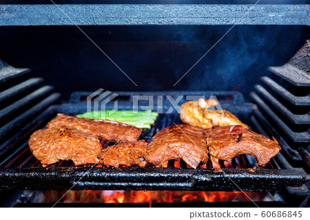 Grilling pork ribs in stove close up 60686845