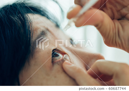 Woman use eye drop, artificial tears to the eye Woman use eye drop, artificial tears to the eye 60687744