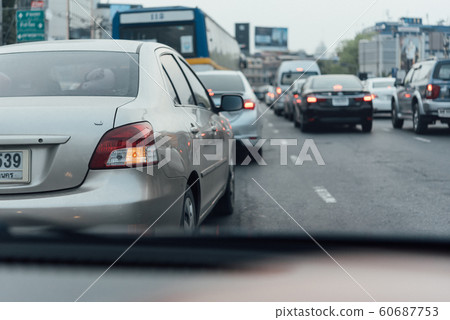 Cars on busy road in the city with traffic jam Cars on busy road in the city with traffic jam 60687753