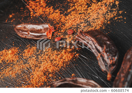 Carob fruit on a black textured background in the Carob fruit on a black textured background in the 60688574