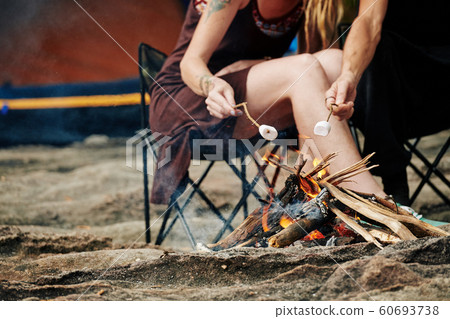 Travelers frying marshmallows 60693738