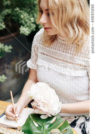 Romantic woman writing in diary Romantic woman writing in diary 60693898