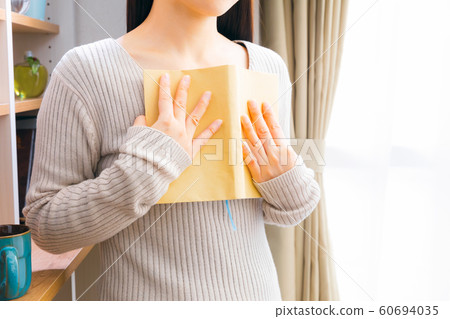 A woman holding a book 60694035
