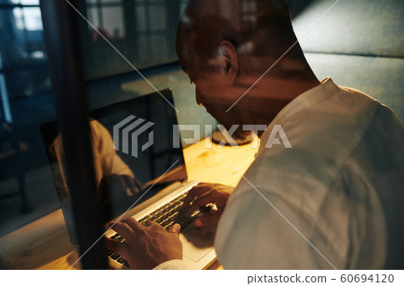 Businessman finishing project late at night Businessman finishing project late at night 60694120