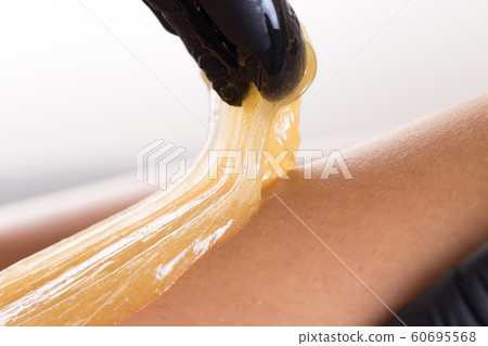 Hair removal process on female leg with epilation 60695568