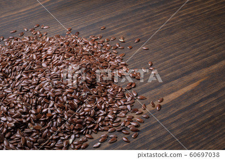 Linseeds on a wooden table. Nutrition source and vitamins Linseeds on a wooden table. Nutrition source and vitamins 60697038