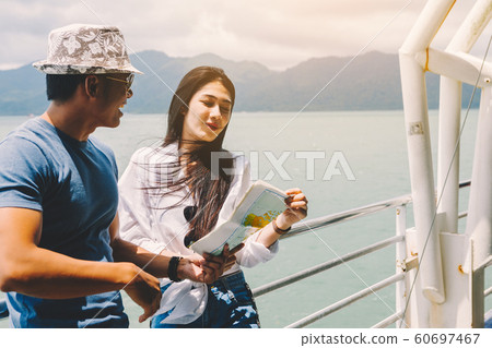 happy tourists talking about planning travel on 60697467