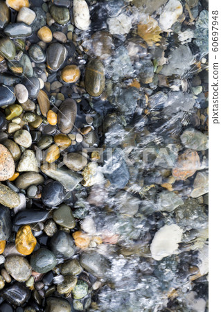 pebbles in wave 60697948