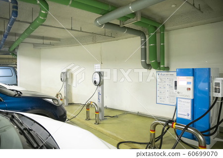 Smart mobility life concept, young man using an electric car, electric vehicle 253 Smart mobility life concept, young man using an electric car, electric vehicle 253 60699070