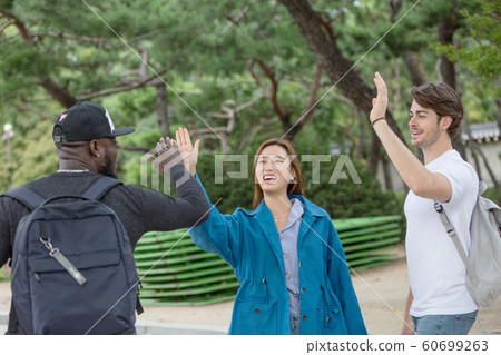 Holidays and tourism concept, group of smiling friends traveling in Seoul, Korea 516 Holidays and tourism concept, group of smiling friends traveling in Seoul, Korea 516 60699263