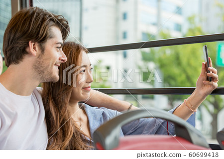 Holidays and tourism concept, group of smiling friends traveling in Seoul, Korea 512 Holidays and tourism concept, group of smiling friends traveling in Seoul, Korea 512 60699418