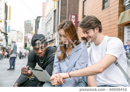 Holidays and tourism concept, group of smiling friends traveling in Seoul, Korea 486 Holidays and tourism concept, group of smiling friends traveling in Seoul, Korea 486 60699458