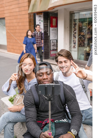 Holidays and tourism concept, group of smiling friends traveling in Seoul, Korea 420 Holidays and tourism concept, group of smiling friends traveling in Seoul, Korea 420 60699463