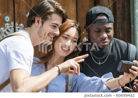 Holidays and tourism concept, group of smiling friends traveling in Seoul, Korea 464 Holidays and tourism concept, group of smiling friends traveling in Seoul, Korea 464 60699482