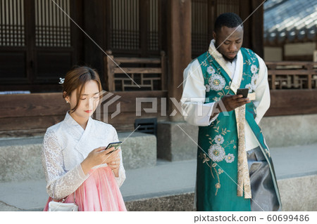 Holidays and tourism concept, group of smiling friends traveling in Seoul, Korea 449 Holidays and tourism concept, group of smiling friends traveling in Seoul, Korea 449 60699486