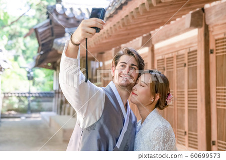 Holidays and tourism concept, group of smiling friends traveling in Seoul, Korea 357 60699573