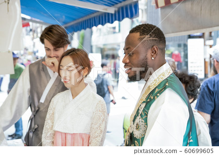 Holidays and tourism concept, group of smiling friends traveling in Seoul, Korea 292 Holidays and tourism concept, group of smiling friends traveling in Seoul, Korea 292 60699605