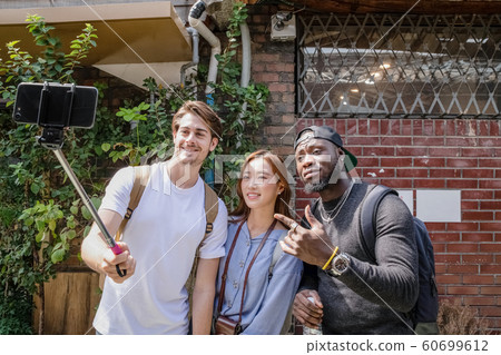 Holidays and tourism concept, group of smiling friends traveling in Seoul, Korea 245 Holidays and tourism concept, group of smiling friends traveling in Seoul, Korea 245 60699612