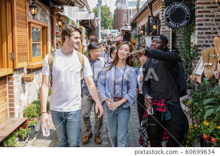 Holidays and tourism concept, group of smiling friends traveling in Seoul, Korea 267 Holidays and tourism concept, group of smiling friends traveling in Seoul, Korea 267 60699634
