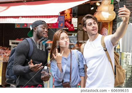 Holidays and tourism concept, group of smiling friends traveling in Seoul, Korea 279 Holidays and tourism concept, group of smiling friends traveling in Seoul, Korea 279 60699635