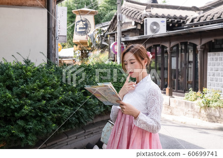 Holidays and tourism concept, group of smiling friends traveling in Seoul, Korea 234 Holidays and tourism concept, group of smiling friends traveling in Seoul, Korea 234 60699741