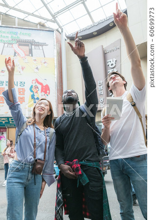 Holidays and tourism concept, group of smiling friends traveling in Seoul, Korea 164 Holidays and tourism concept, group of smiling friends traveling in Seoul, Korea 164 60699773