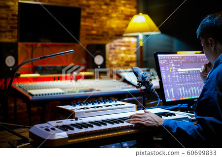 music producer arranging a song on computer in recording studio. music production concept 60699833