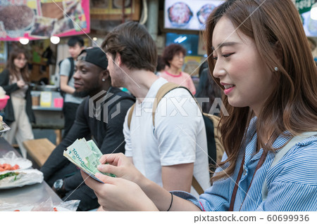 Holidays and tourism concept, group of smiling friends traveling in Seoul, Korea 104 Holidays and tourism concept, group of smiling friends traveling in Seoul, Korea 104 60699936