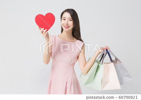 Happy single woman life, an attractive smiling woman holding shopping bags 348 Happy single woman life, an attractive smiling woman holding shopping bags 348 60700821
