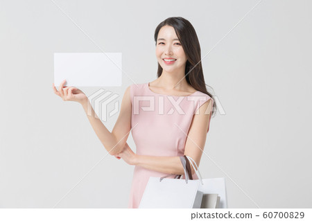 Happy single woman life, an attractive smiling woman holding shopping bags 398 Happy single woman life, an attractive smiling woman holding shopping bags 398 60700829