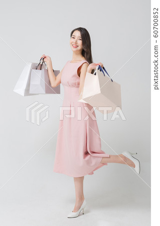 Happy single woman life, an attractive smiling woman holding shopping bags 308 Happy single woman life, an attractive smiling woman holding shopping bags 308 60700852