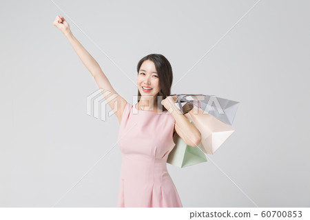 Happy single woman life, an attractive smiling woman holding shopping bags 378 Happy single woman life, an attractive smiling woman holding shopping bags 378 60700853