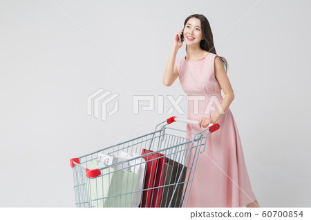 Happy single woman life, an attractive smiling woman holding shopping bags 438 Happy single woman life, an attractive smiling woman holding shopping bags 438 60700854