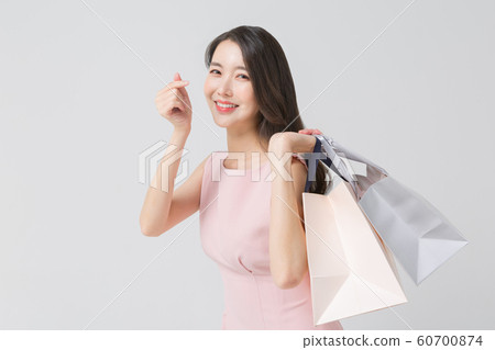 Happy single woman life, an attractive smiling woman holding shopping bags 414 Happy single woman life, an attractive smiling woman holding shopping bags 414 60700874