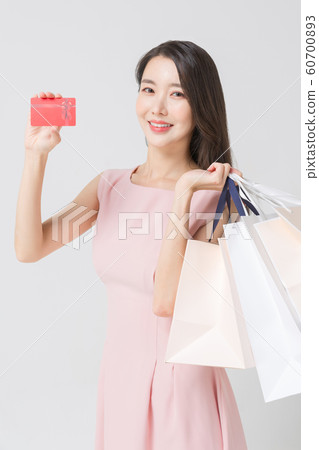 Happy single woman life, an attractive smiling woman holding shopping bags 401 Happy single woman life, an attractive smiling woman holding shopping bags 401 60700893