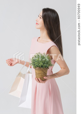 Happy single woman life, an attractive smiling woman holding shopping bags 337 Happy single woman life, an attractive smiling woman holding shopping bags 337 60700949