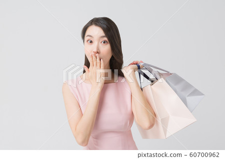 Happy single woman life, an attractive smiling woman holding shopping bags 434 60700962