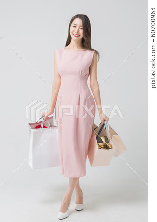 Happy single woman life, an attractive smiling woman holding shopping bags 341 Happy single woman life, an attractive smiling woman holding shopping bags 341 60700963