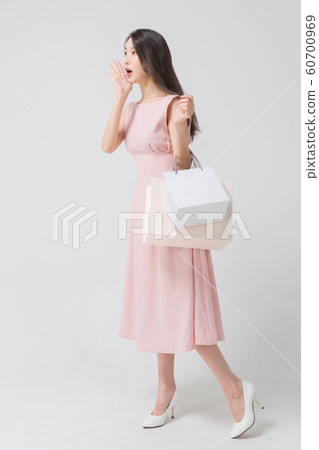 Happy single woman life, an attractive smiling woman holding shopping bags 305 Happy single woman life, an attractive smiling woman holding shopping bags 305 60700969